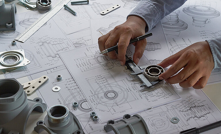 Engineer technician designing drawings mechanical parts enginee